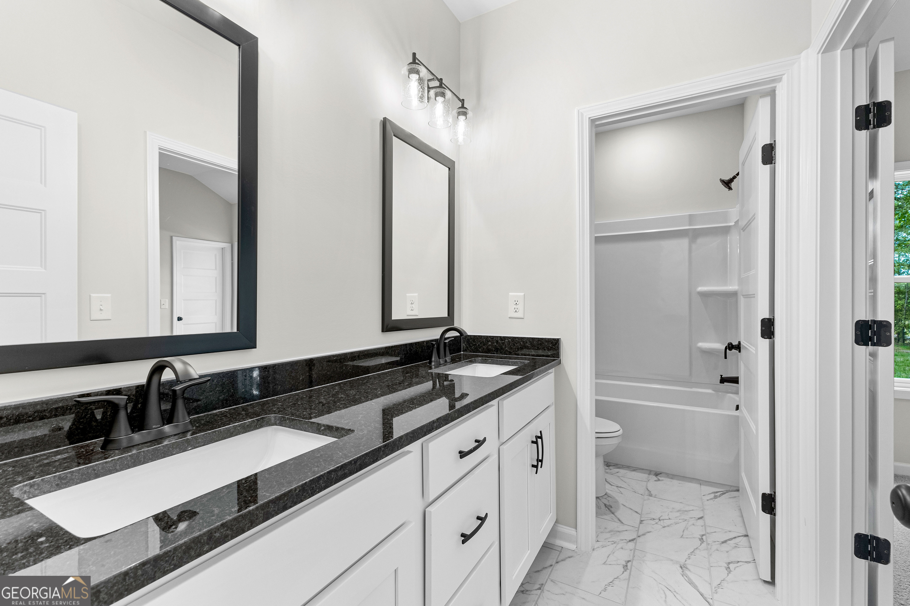 1210 Waymanville Road Thomaston, GA 30286 - Photo 28 of 45 a bathroom with a sink double vanity and a bathtub