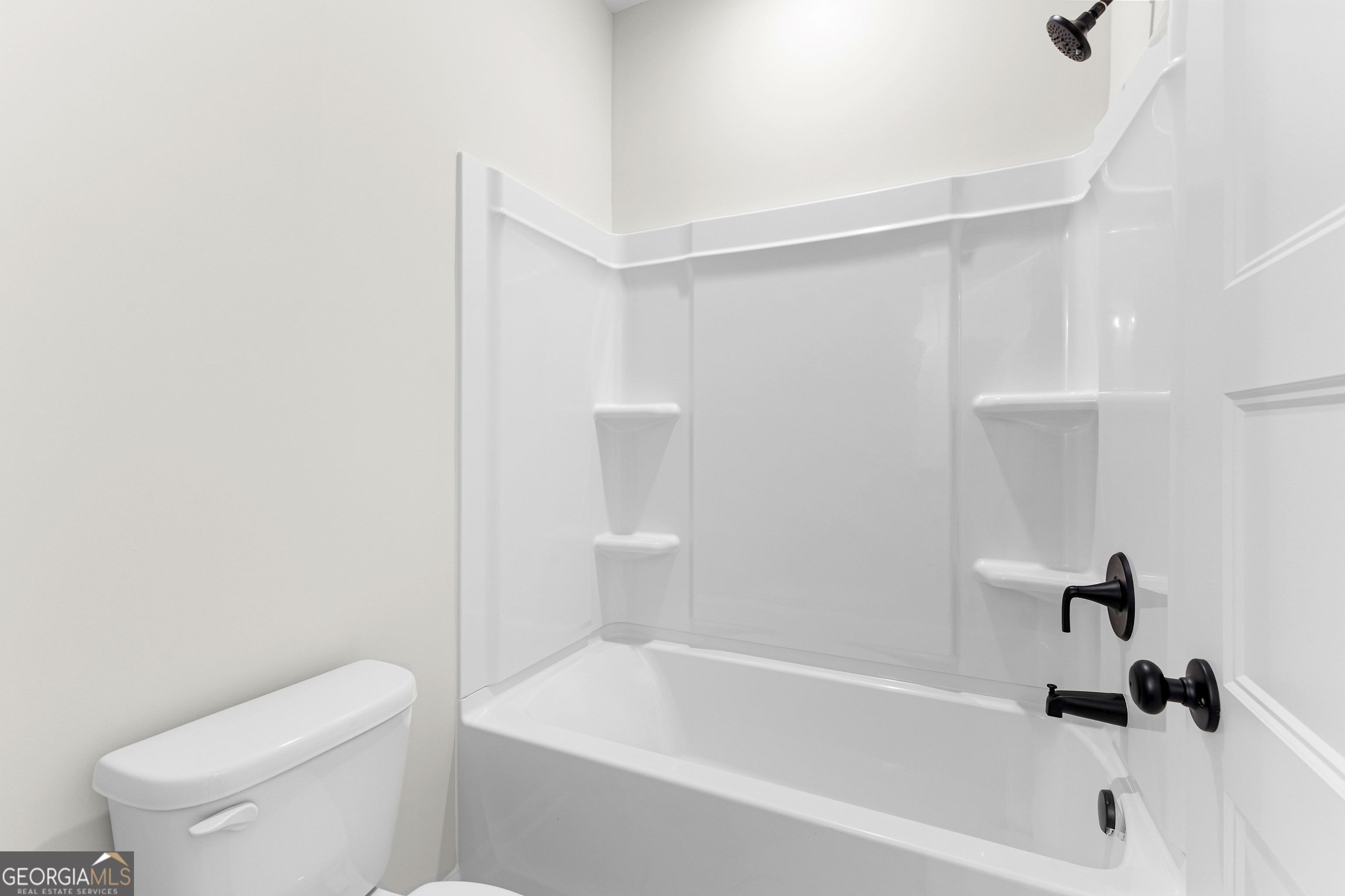 1210 Waymanville Road Thomaston, GA 30286 - Photo 29 of 45 a white bath tub sitting next to a white toilet and wooden vanity