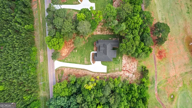 an aerial view of a house with a yard and garden