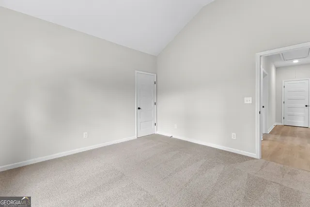 an empty room with windows and closet