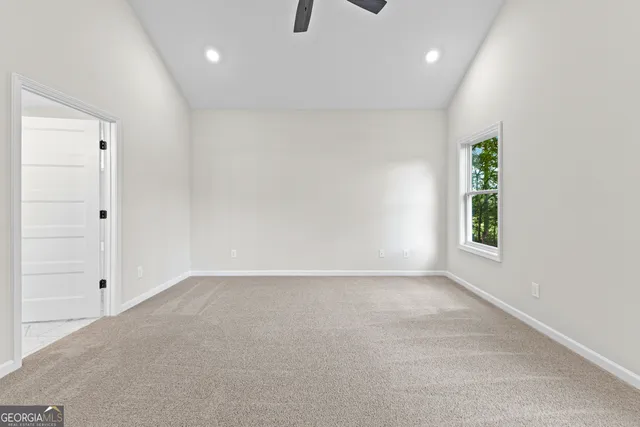 a spacious bathroom with a granite countertop sink and a mirror
