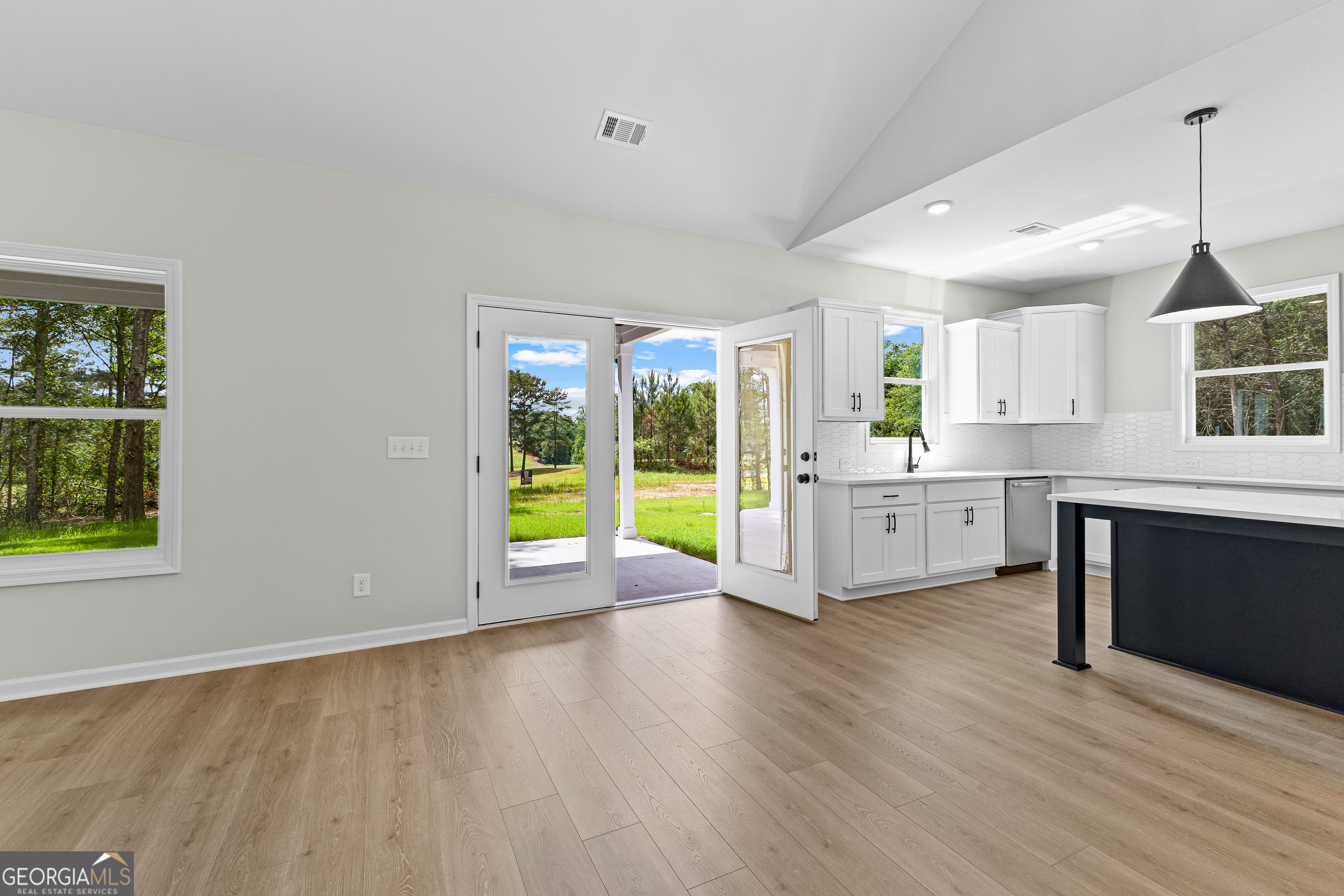 1210 Waymanville Road Thomaston, GA 30286 - Photo 41 of 45 a view of an empty room with a window and wooden floor