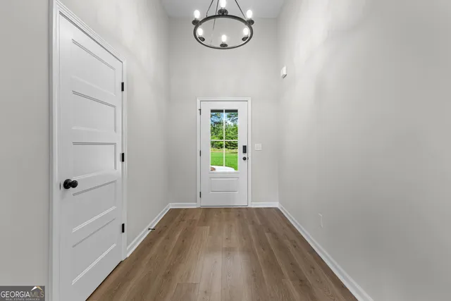 a view of room with window and wooden floor