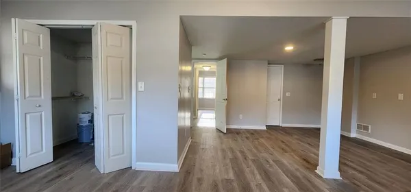 a view of hallway with wooden floor