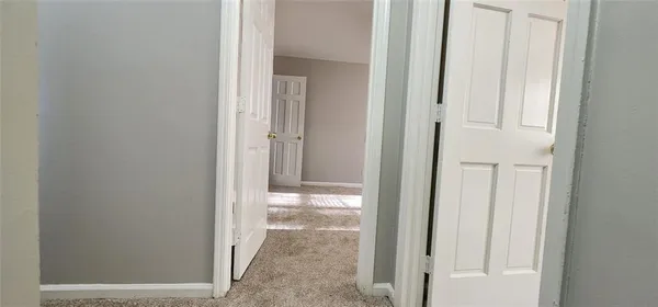 a view of an empty room with windows and closet