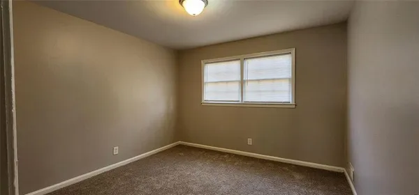 a view of a hallway with a wooden door