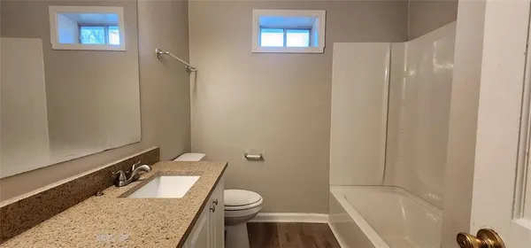 a view of a hallway with entryway wooden floor and stairs