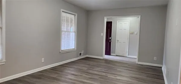 wooden floor in an empty room and a mirror