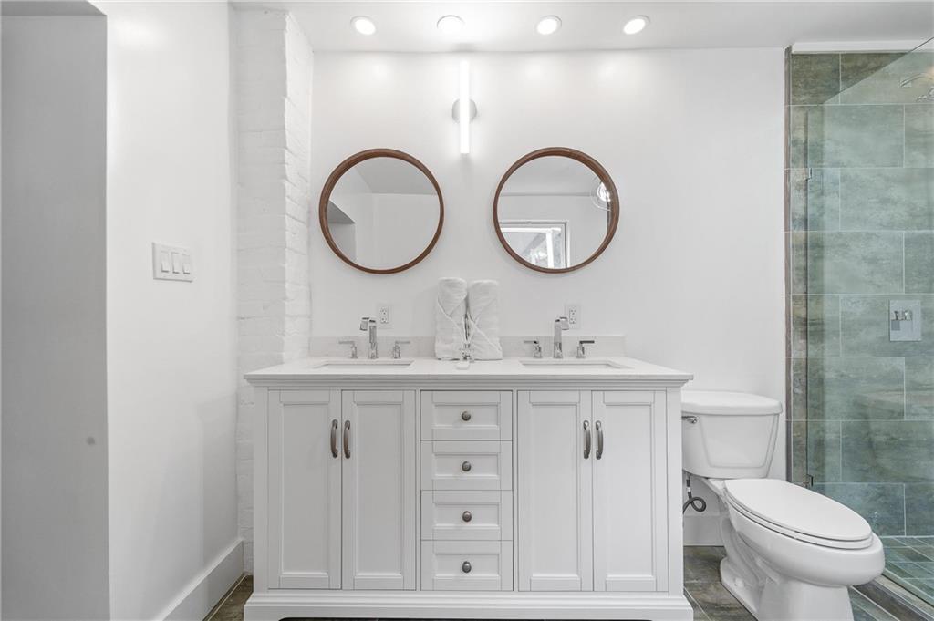 16 5th Street Carnegie, PA 15106 - Photo 18 of 31 a bathroom with a granite countertop toilet a sink and a mirror