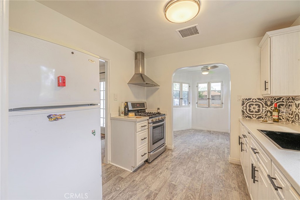 44603 Fig Avenue Lancaster, CA 93534 - Photo 13 of 39 a kitchen with granite countertop white cabinets and white appliances