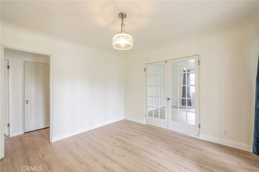 44603 Fig Avenue Lancaster, CA 93534 - Photo 20 of 39 an empty room with wooden floor and windows