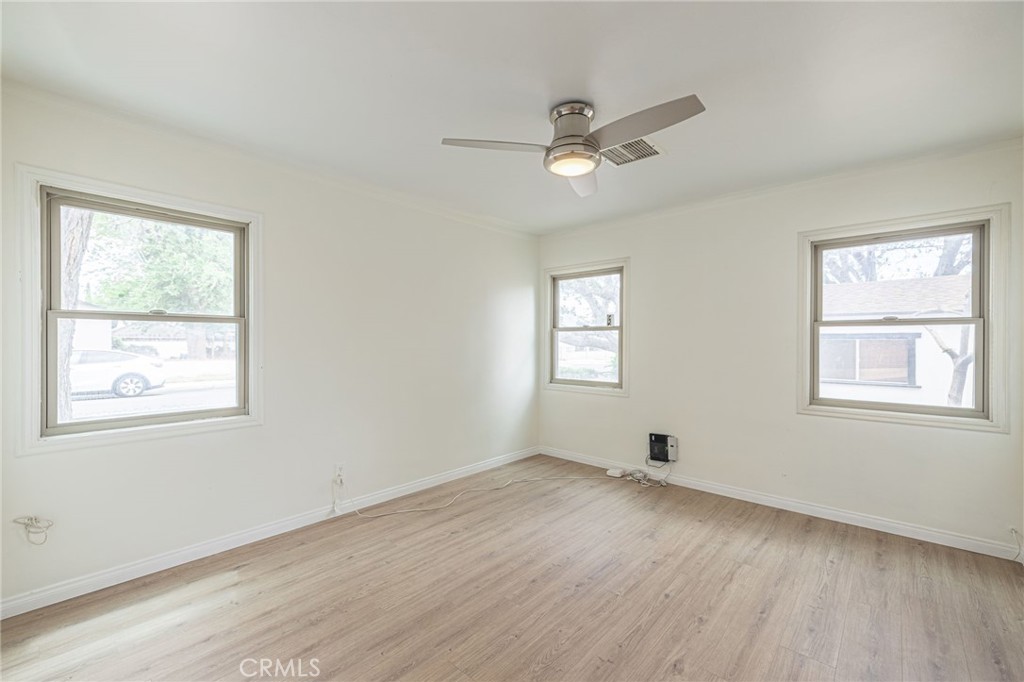 44603 Fig Avenue Lancaster, CA 93534 - Photo 23 of 39 a view of empty room with wooden floor and fan