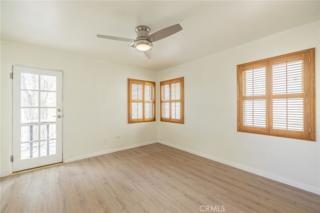 44603 Fig Avenue Lancaster, CA 93534 - Photo 27 of 39 a view of an empty room with a window and wooden floor