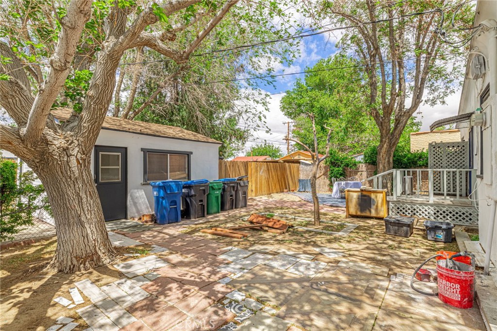 44603 Fig Avenue Lancaster, CA 93534 - Photo 31 of 39 a view of a chair and table in the backyard