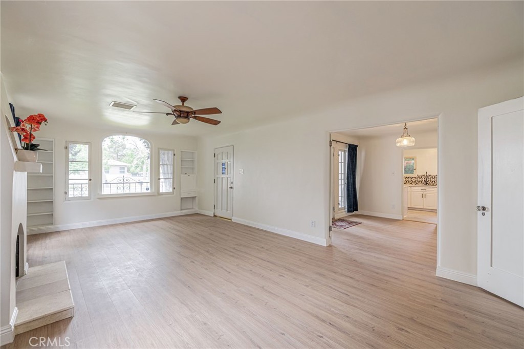 44603 Fig Avenue Lancaster, CA 93534 - Photo 8 of 39 an empty room with wooden floor cabinet and windows