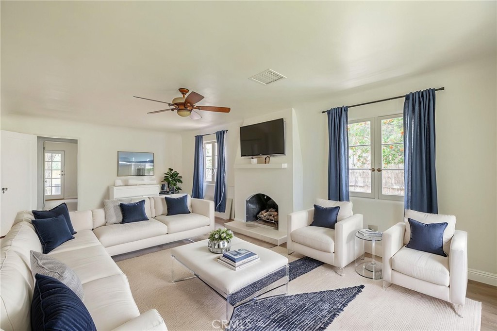 44603 Fig Avenue Lancaster, CA 93534 - Photo 10 of 39 a living room with furniture a fireplace and a window