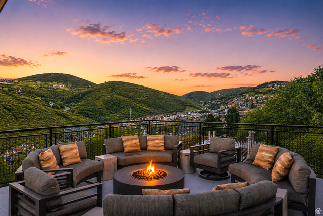1258 Rothwell Road Park City, UT 84060 - Photo 39 of 48 Spacious outdoor patio featuring a central fire pit, panoramic mountain scenery, and a black metal railing