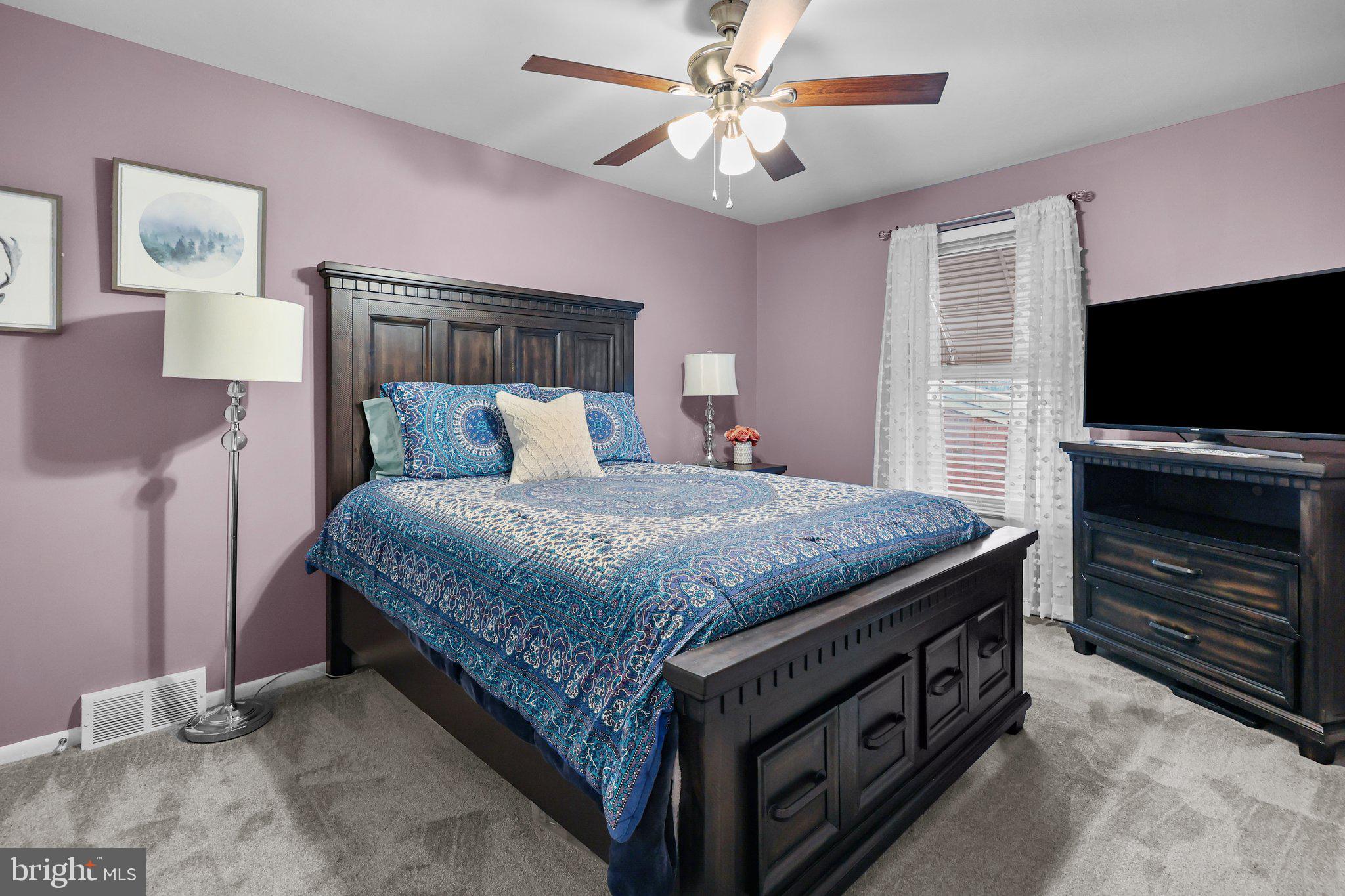 185 Greendale Road Philadelphia, PA 19154 - Photo 14 of 26 a spacious bedroom with a bed and a flat screen tv