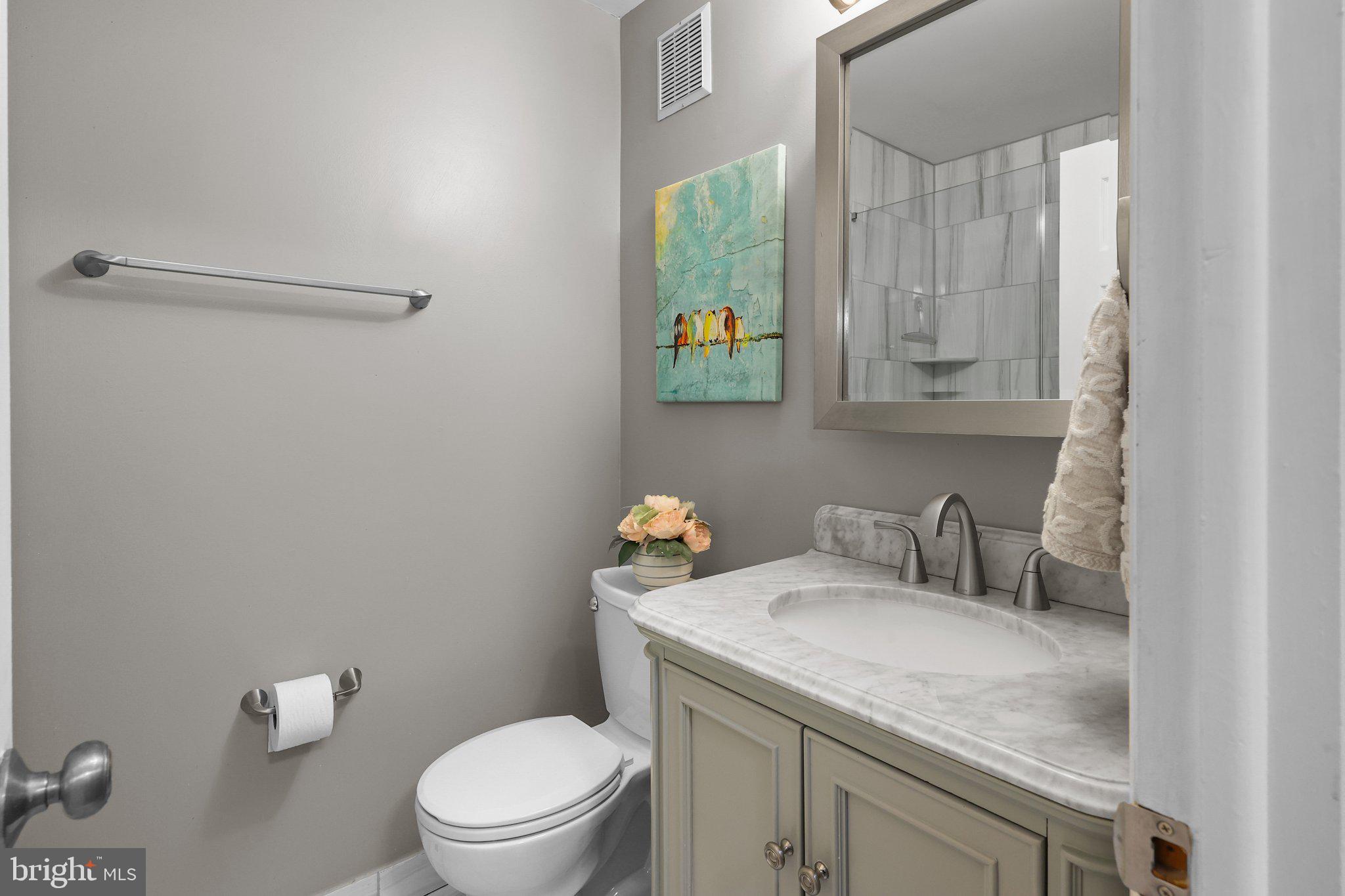 185 Greendale Road Philadelphia, PA 19154 - Photo 18 of 26 a bathroom with a granite countertop sink a toilet and a mirror
