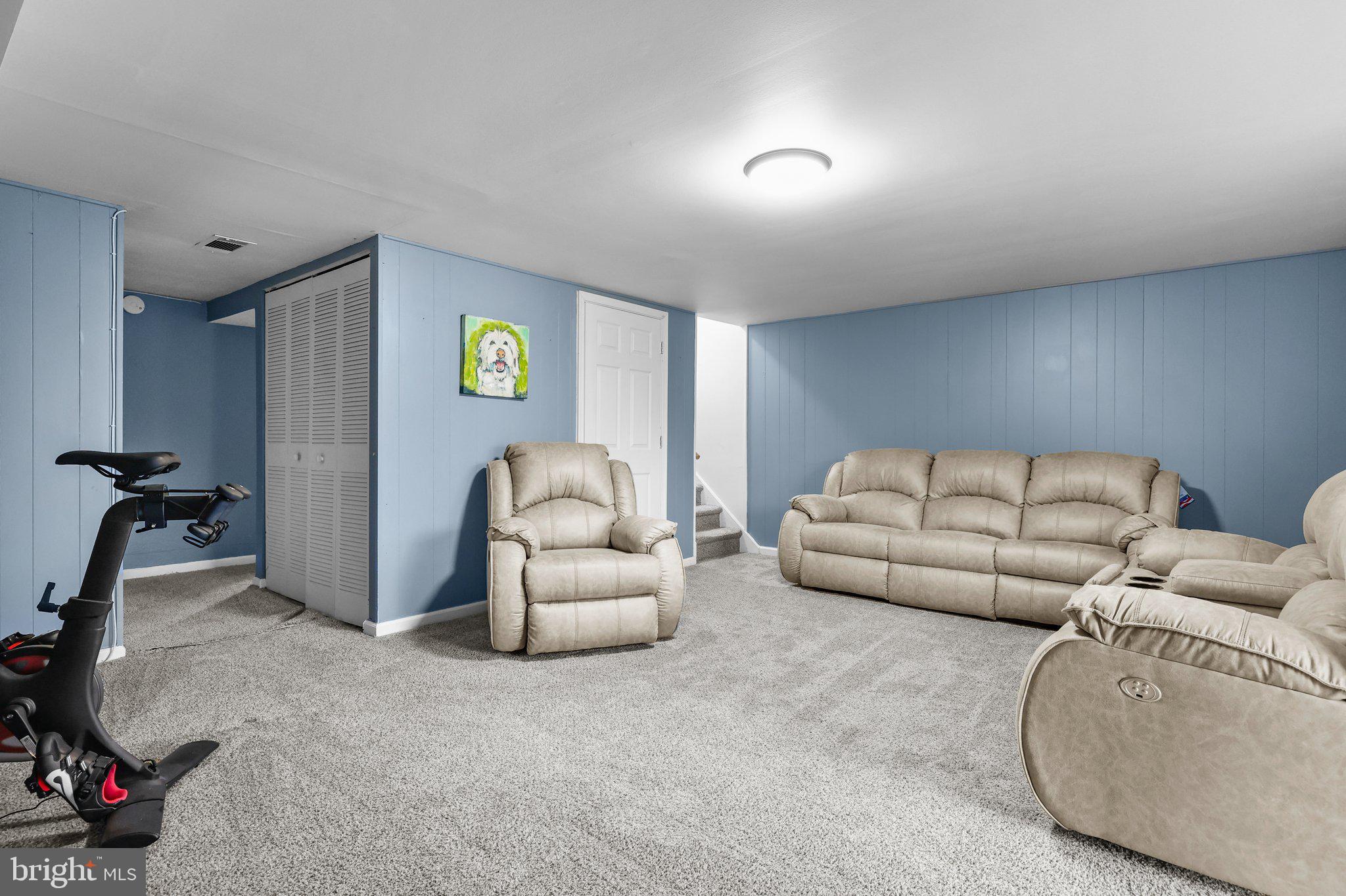 185 Greendale Road Philadelphia, PA 19154 - Photo 21 of 26 a living room with furniture and a gym machine