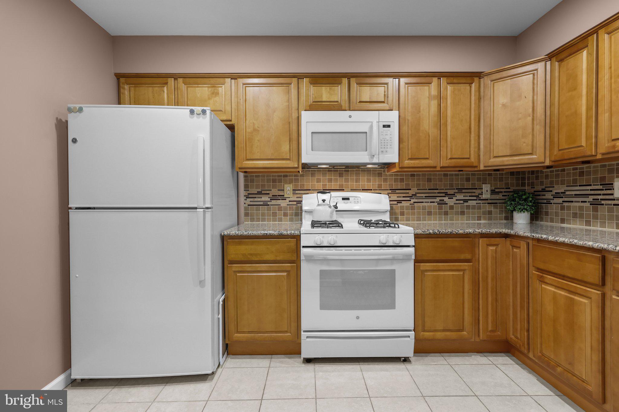 185 Greendale Road Philadelphia, PA 19154 - Photo 10 of 26 a kitchen with refrigerator and cabinets