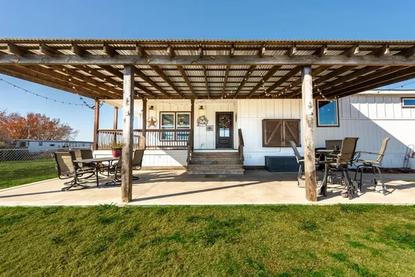 a view of yard with a patio and a table and chairs