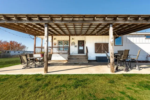 a view of yard with a patio and a table and chairs