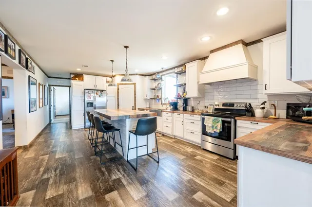 a open kitchen with granite countertop a stove and a sink
