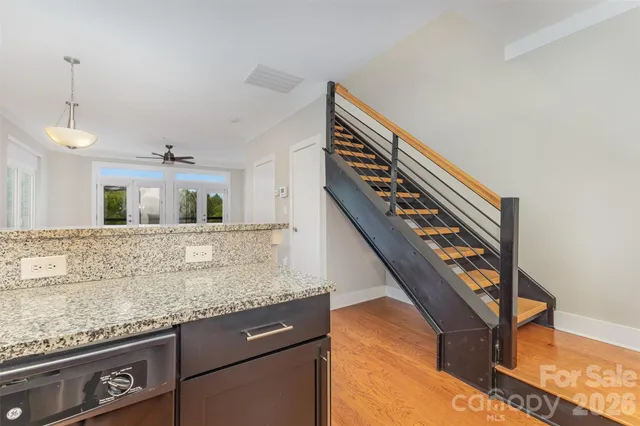 a kitchen with granite countertop stainless steel appliances and wooden cabinets