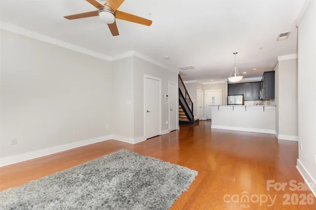 a view of livingroom with hardwood floor and a ceiling fan