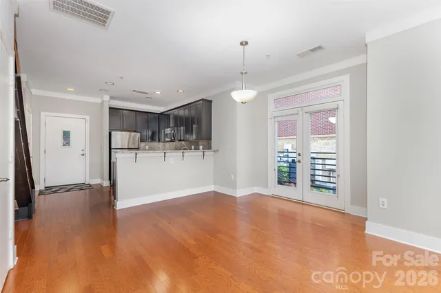 a view of an empty room with a window and ceiling fan