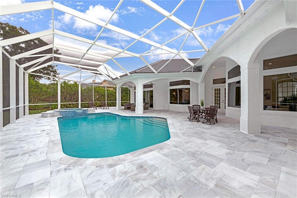669 West Street Naples, FL 34108 - Photo 14 of 22 a view of a house with a swimming pool