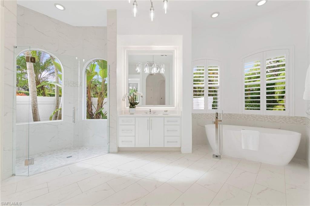 669 West Street Naples, FL 34108 - Photo 17 of 22 a spacious bathroom with windows and bathtub