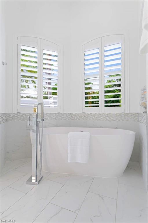 669 West Street Naples, FL 34108 - Photo 18 of 22 a bath tub sitting in a bathroom next to a window