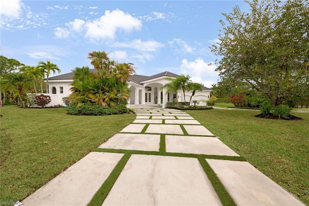 669 West Street Naples, FL 34108 - Photo 22 of 22 a view of a yard with plants and trees