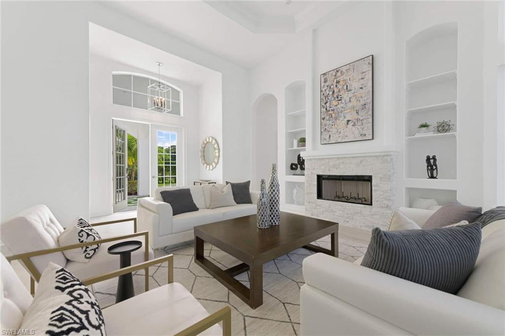 669 West Street Naples, FL 34108 - Photo 4 of 22 a living room with furniture and a fireplace