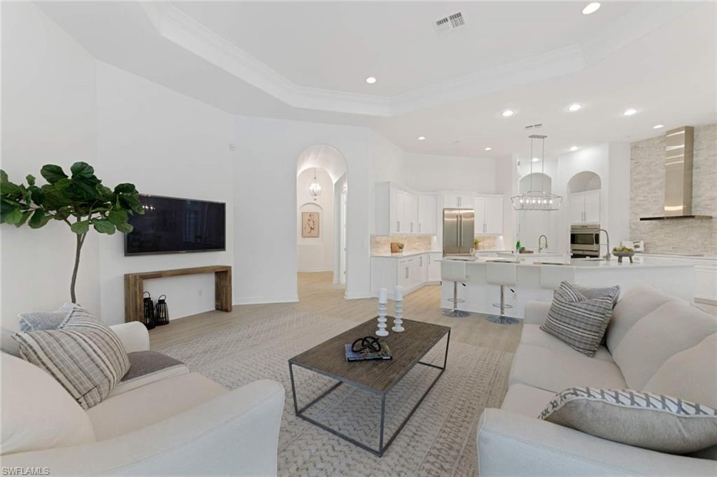 669 West Street Naples, FL 34108 - Photo 6 of 22 a living room with furniture and a flat screen tv