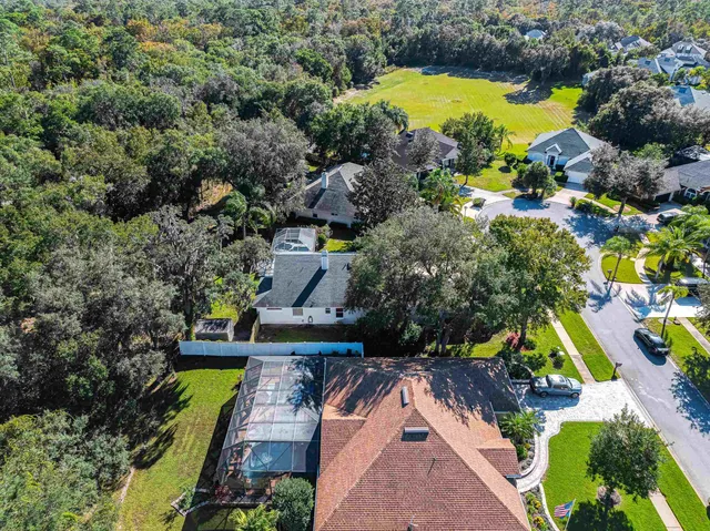 an aerial view of a house with a yard