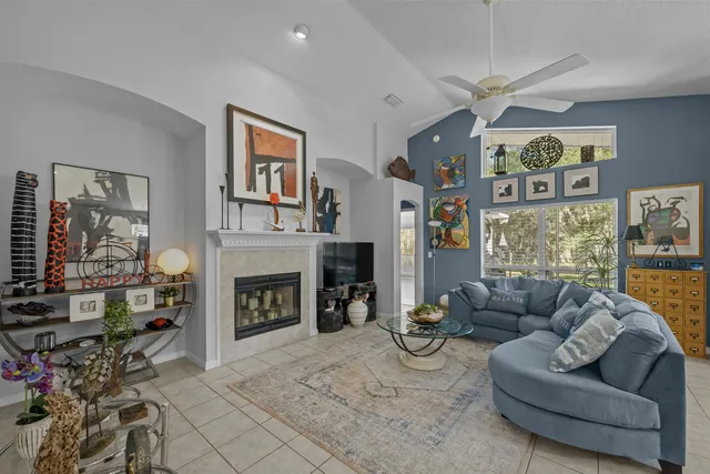 a living room with furniture a chandelier and a fireplace