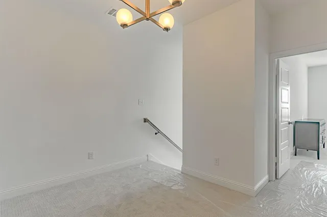 a kitchen with a sink stove and white cabinets with wooden floor