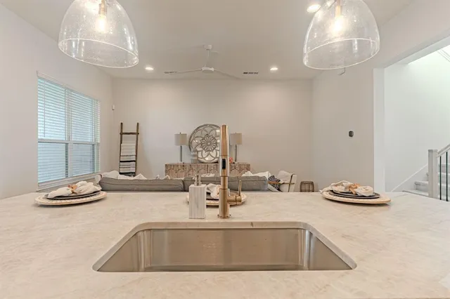 a living room with furniture and a dining table with kitchen view