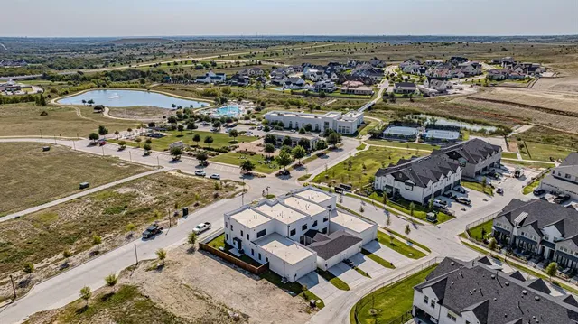 a kitchen with a dining table chairs and white cabinets