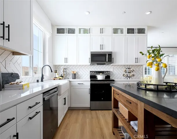 a view of a patio with couches table and chairs and potted plants