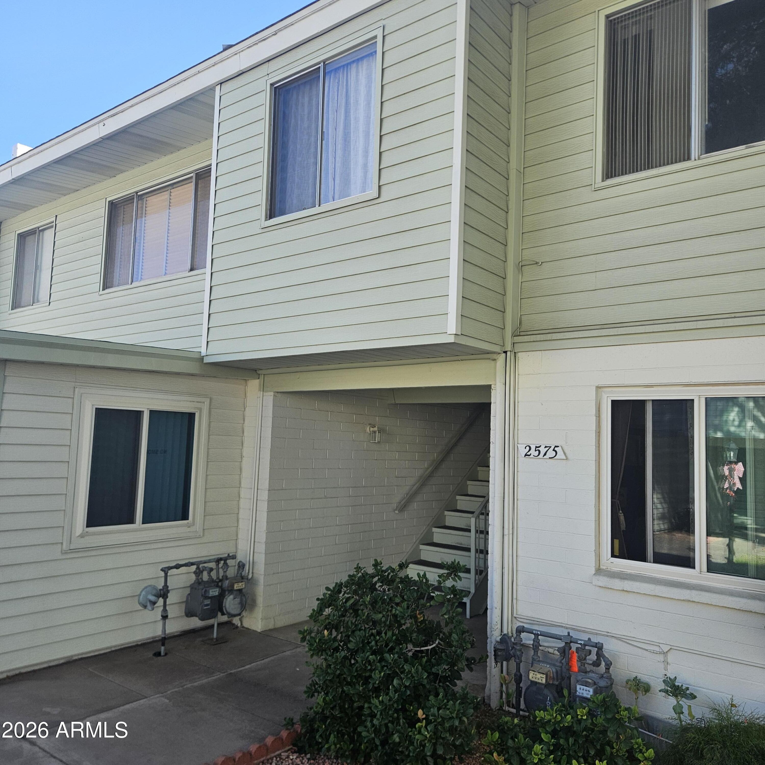 a front view of a house with trees