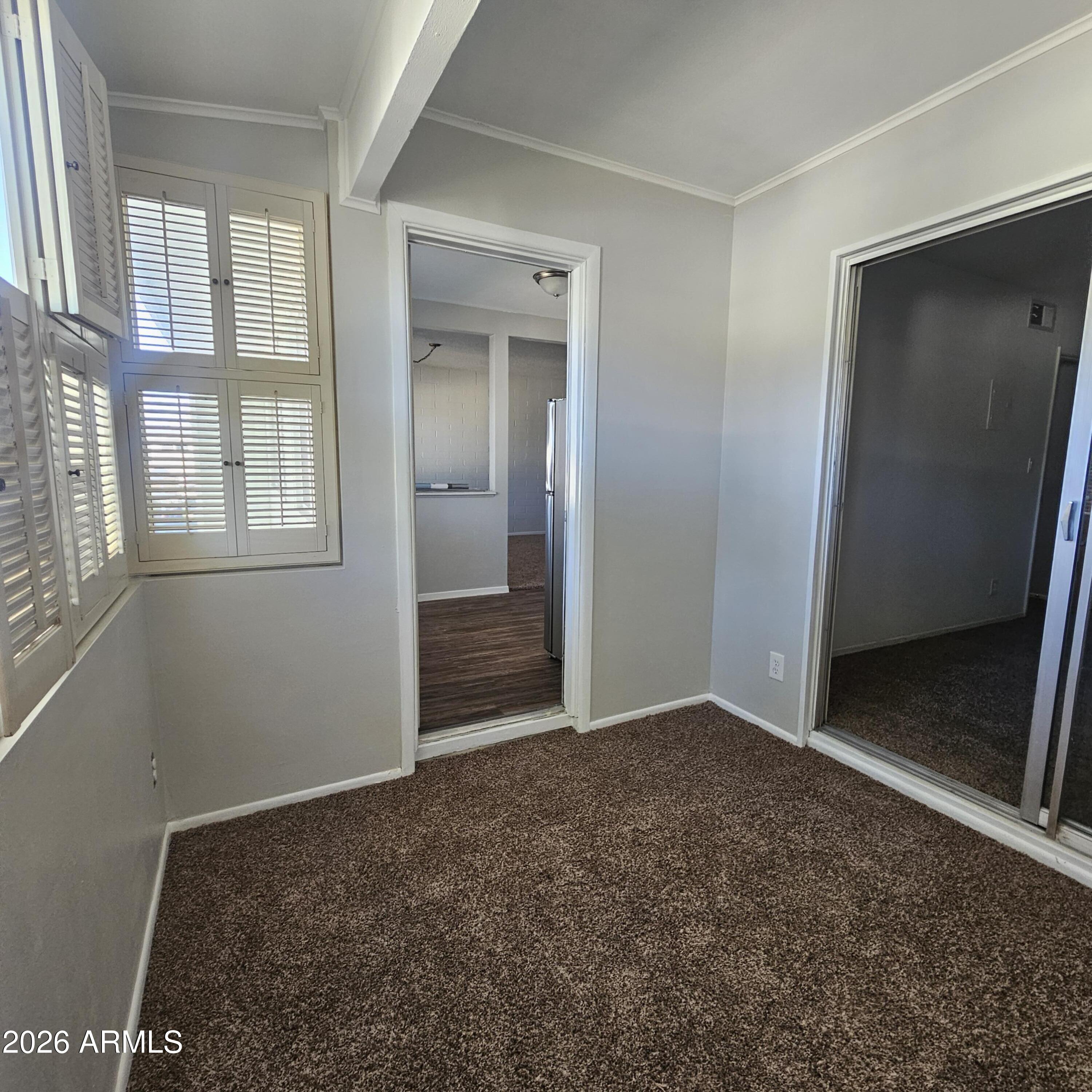 2575 West Berridge Lane, Unit D209 Phoenix, AZ 85017 - Photo 11 of 17 an empty room with windows and closet