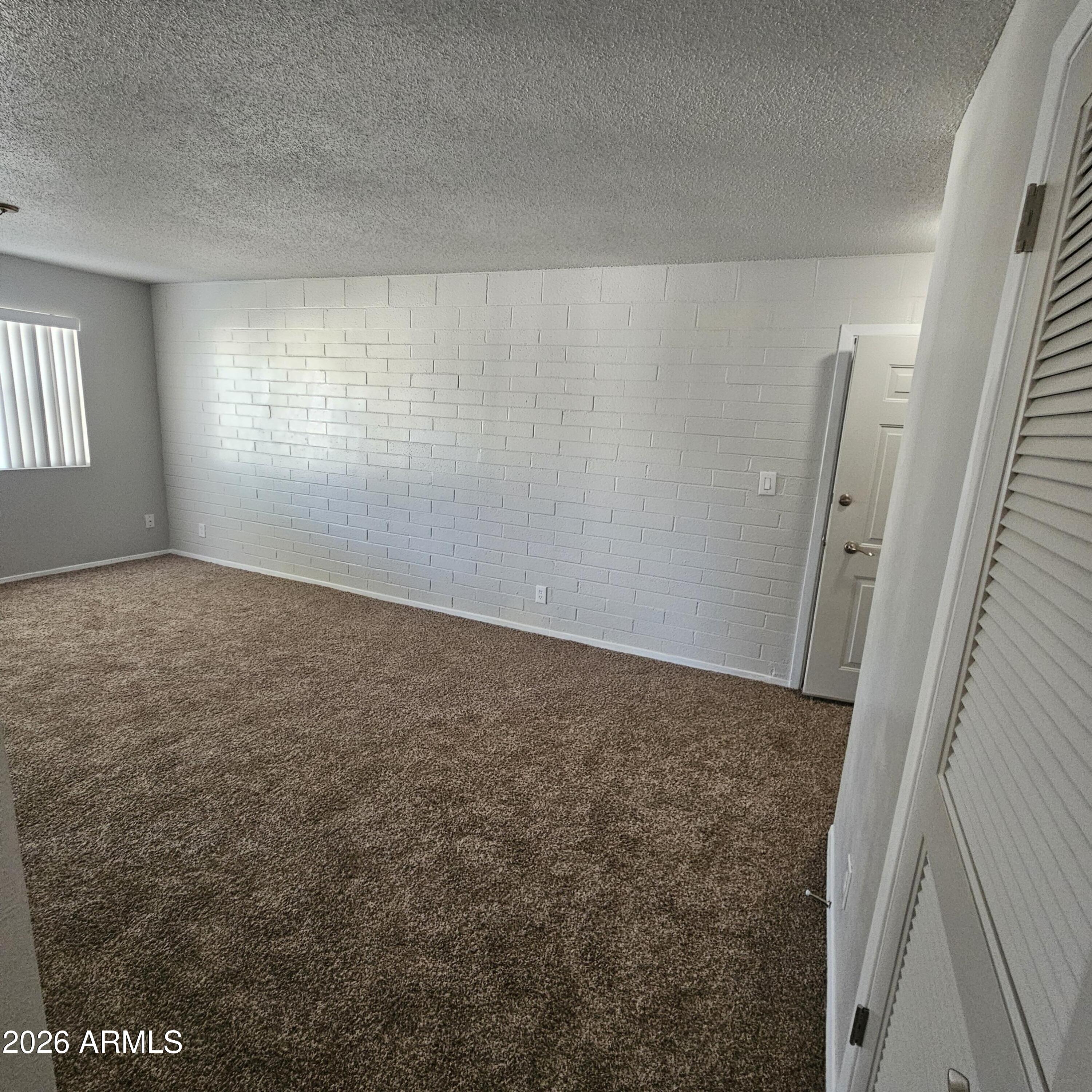 2575 West Berridge Lane, Unit D209 Phoenix, AZ 85017 - Photo 5 of 17 an empty room with windows