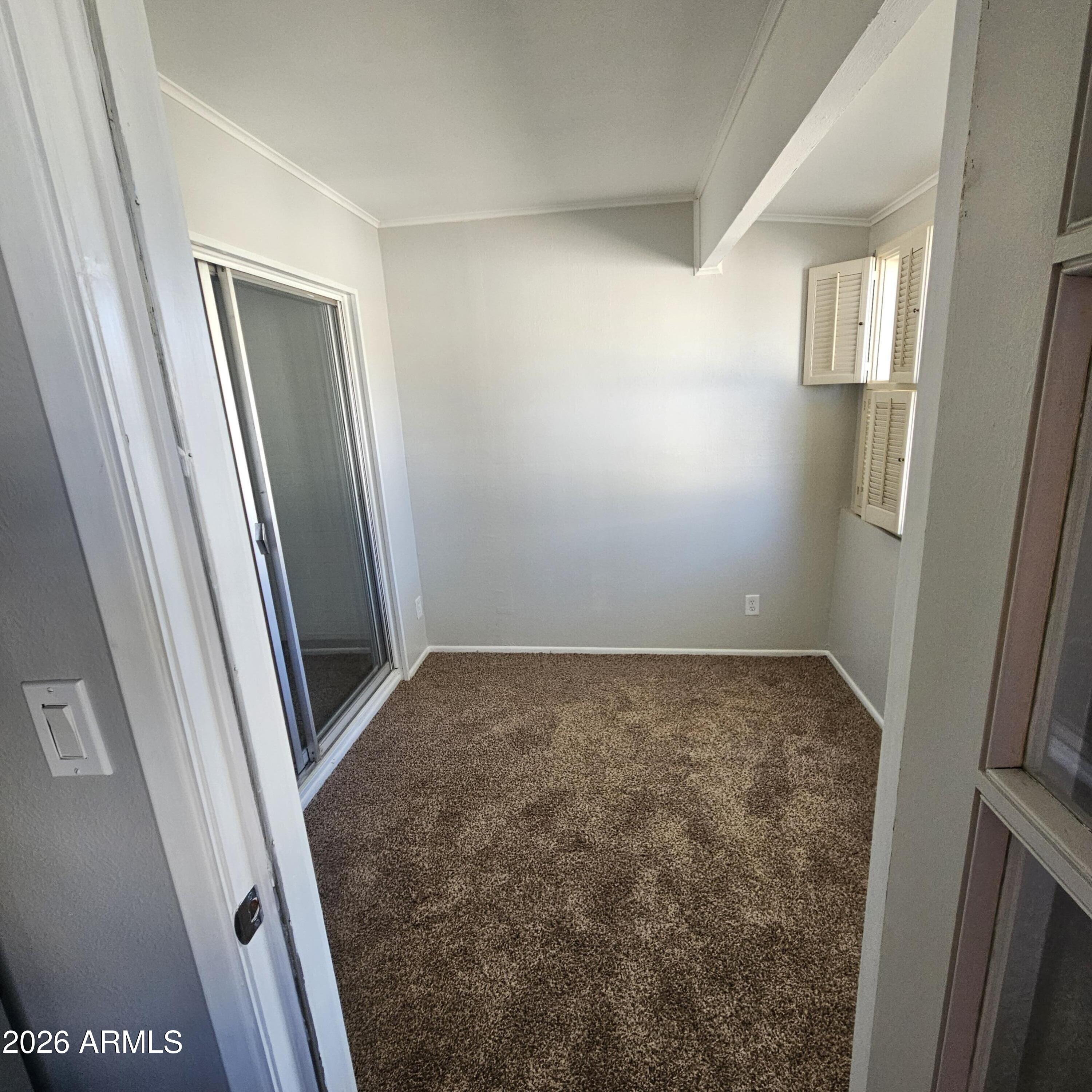 2575 West Berridge Lane, Unit D209 Phoenix, AZ 85017 - Photo 10 of 17 view of room with window and hardwood floor