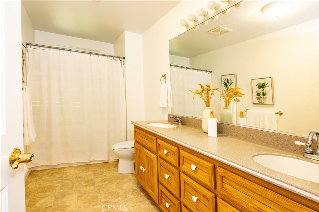 18501 Rustic Ridge Lower Lake, CA 95457 - Photo 22 of 46 a bathroom with a granite countertop sink toilet and shower