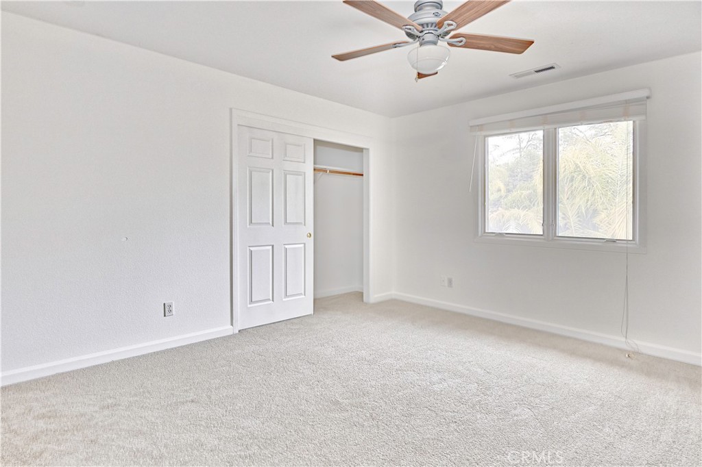 18501 Rustic Ridge Lower Lake, CA 95457 - Photo 24 of 46 an empty room with windows and fan