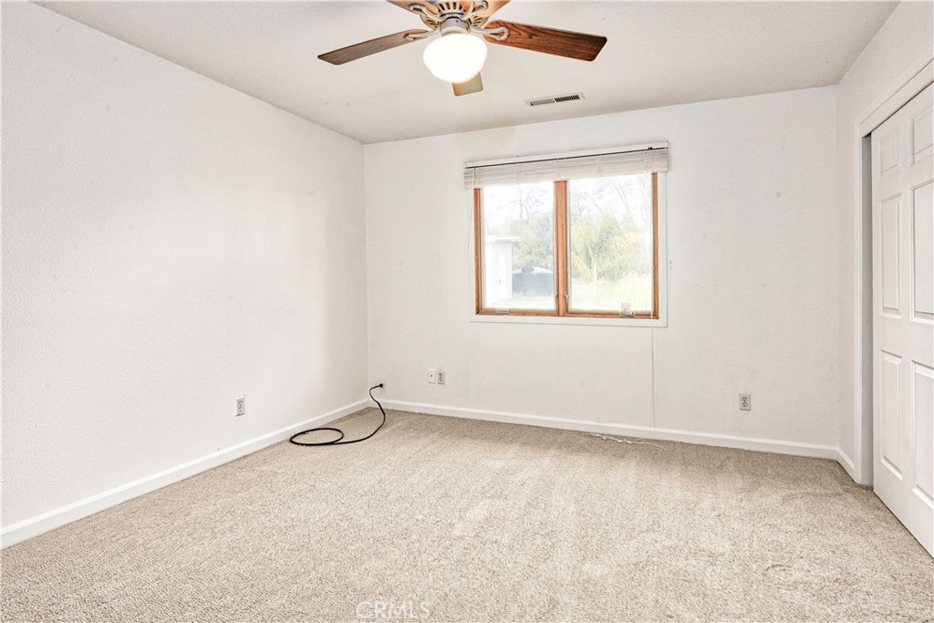 18501 Rustic Ridge Lower Lake, CA 95457 - Photo 28 of 46 an empty room with windows and fan